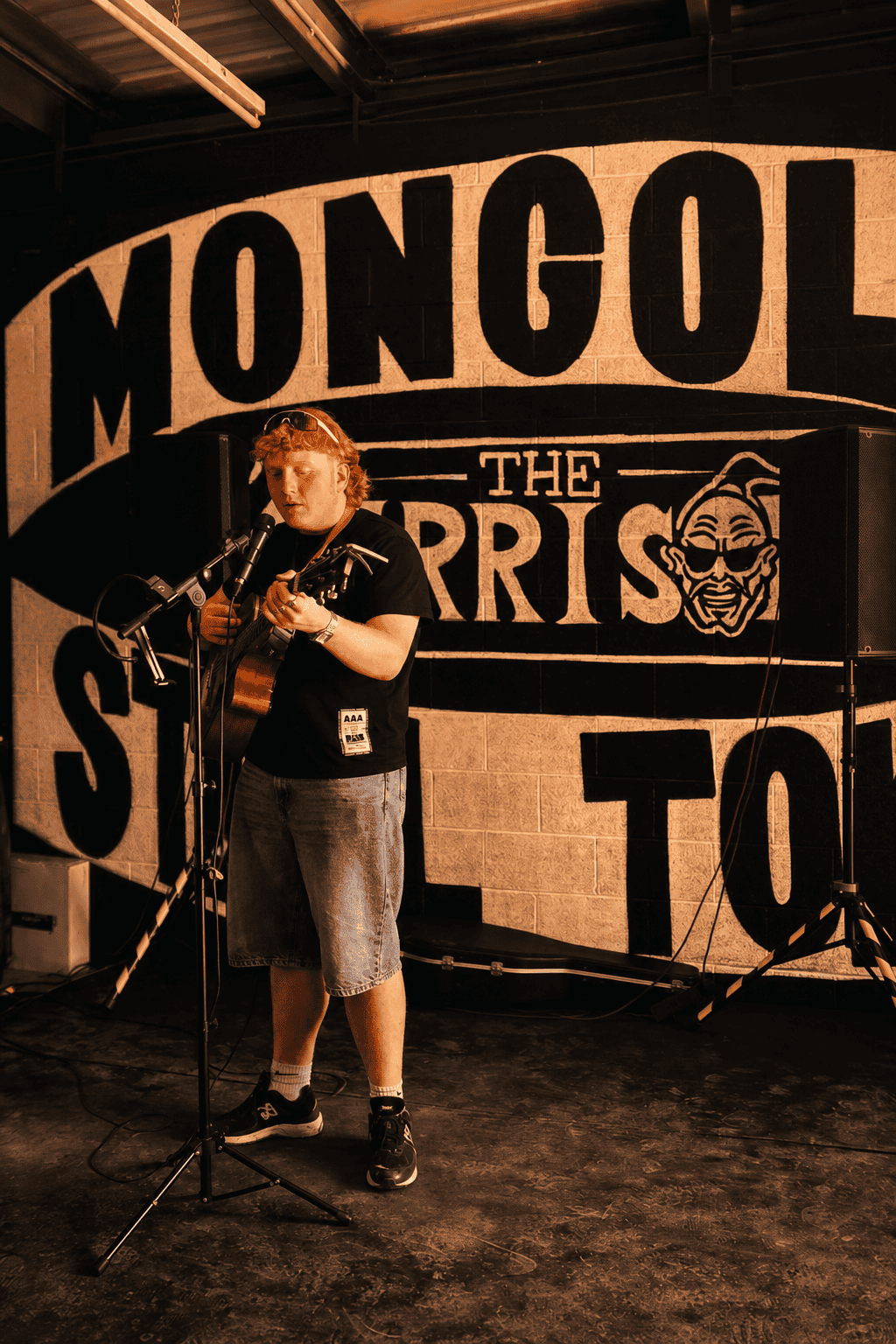 Alfie Kelly singing and playing acoustic guitar at Steel Town